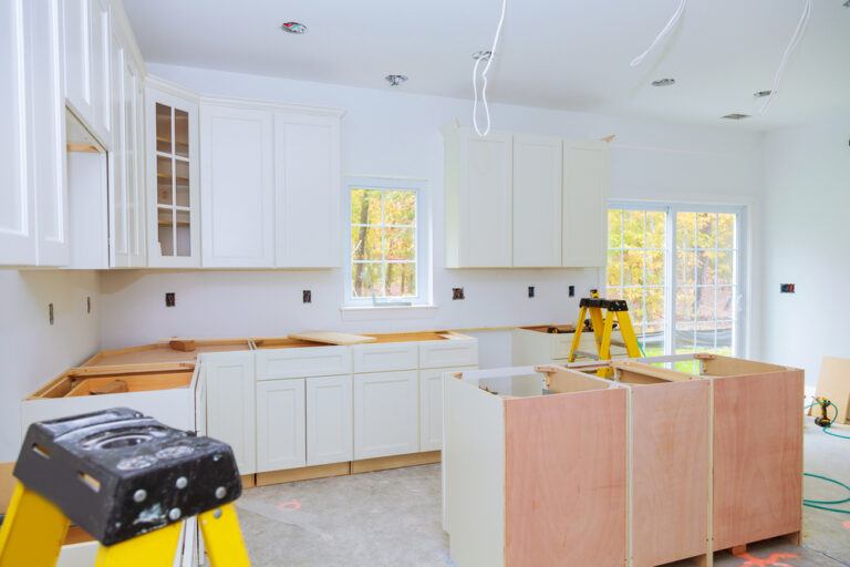 Custom kitchen cabinets being installed with a base for a central island