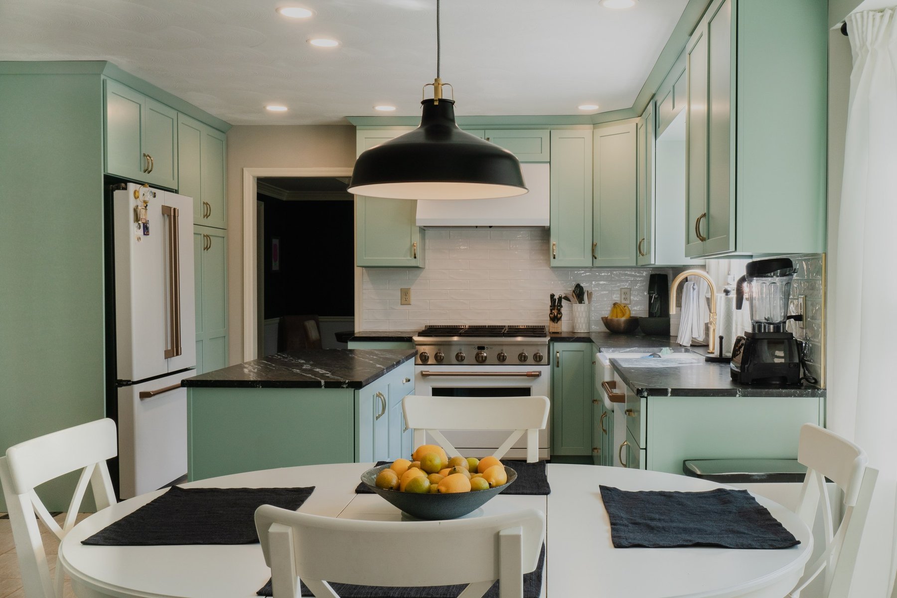 Kitchen remodel with custom wood cabinetry, granite worktops and a tiled backsplash