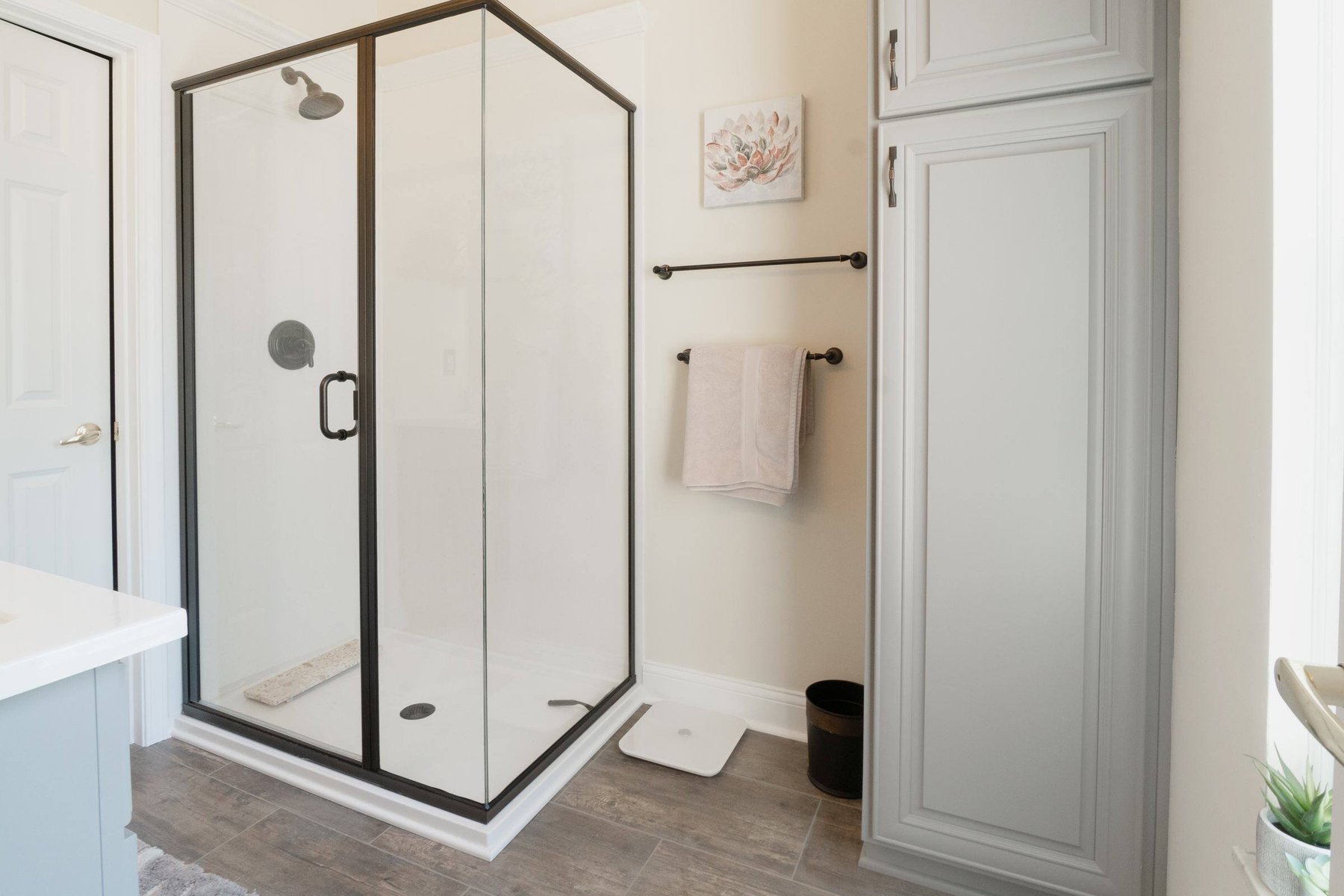 Remodeled bathroom with updated shower, vanity top and flooring