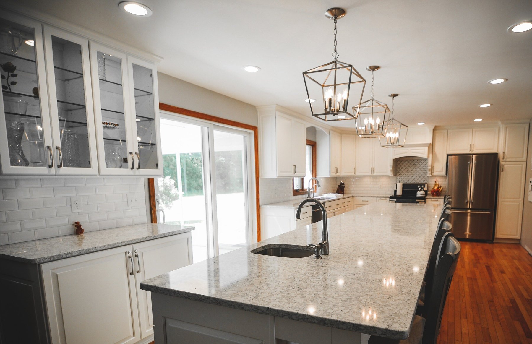 Bright open-plan kitchen remodel with a large island and light cabinetry
