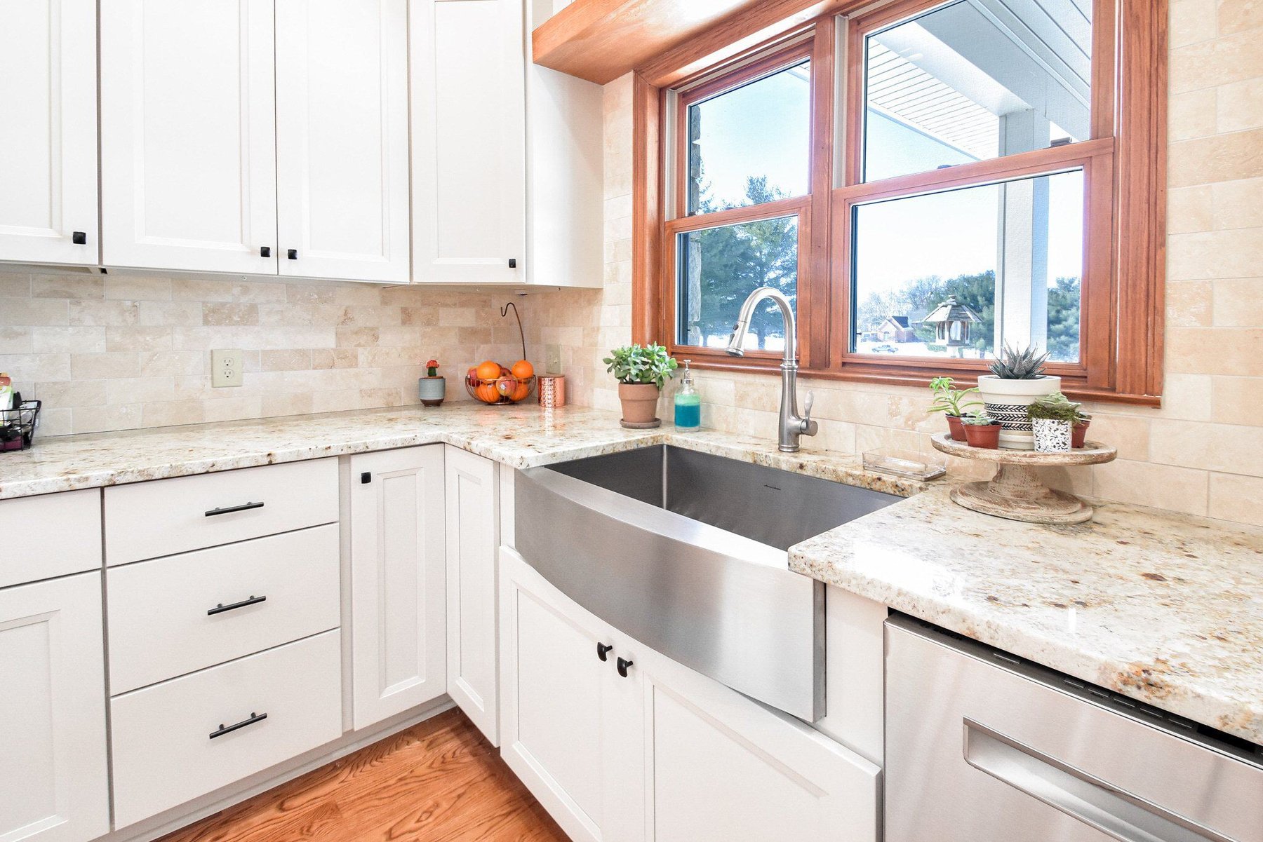 Completed JSB Home Solutions kitchen with white cabinetry and a large island