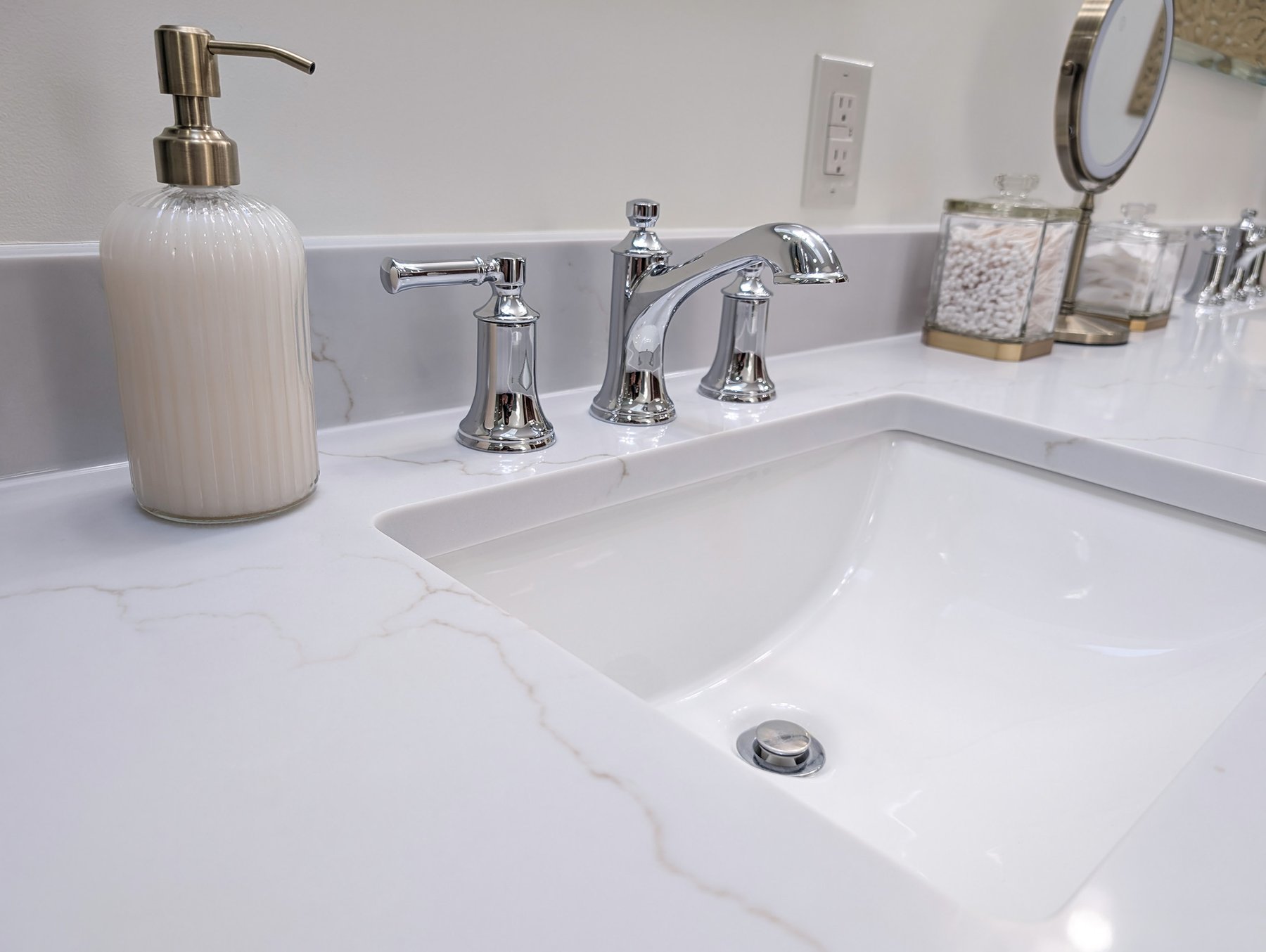 Accessible bathroom with a low-threshold glass shower and a light wood vanity